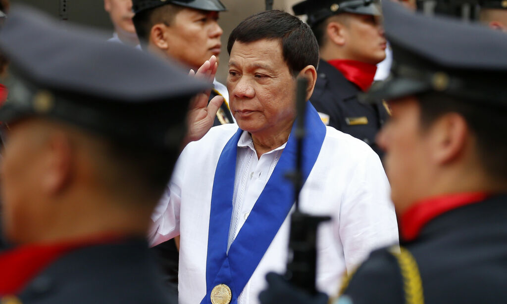 Philippine President Rodrigo Duterte salutes customs police as he arrives to witness the destruction of a fleet of 20 used luxury cars and SUVs as part of the 116th anniversary celebration of the Bureau of Customs in Manila, Philippines Tuesday, Feb. 6, 2018. President Rodrigo Duterte has ordered a stop to all foreign scientific research missions in a vast expanse of waters off the country's northeast and asked navy ships and air force planes to "chase out" fishing and research vessels in the region, an official said Tuesday. (AP Photo/Bullit Marquez)